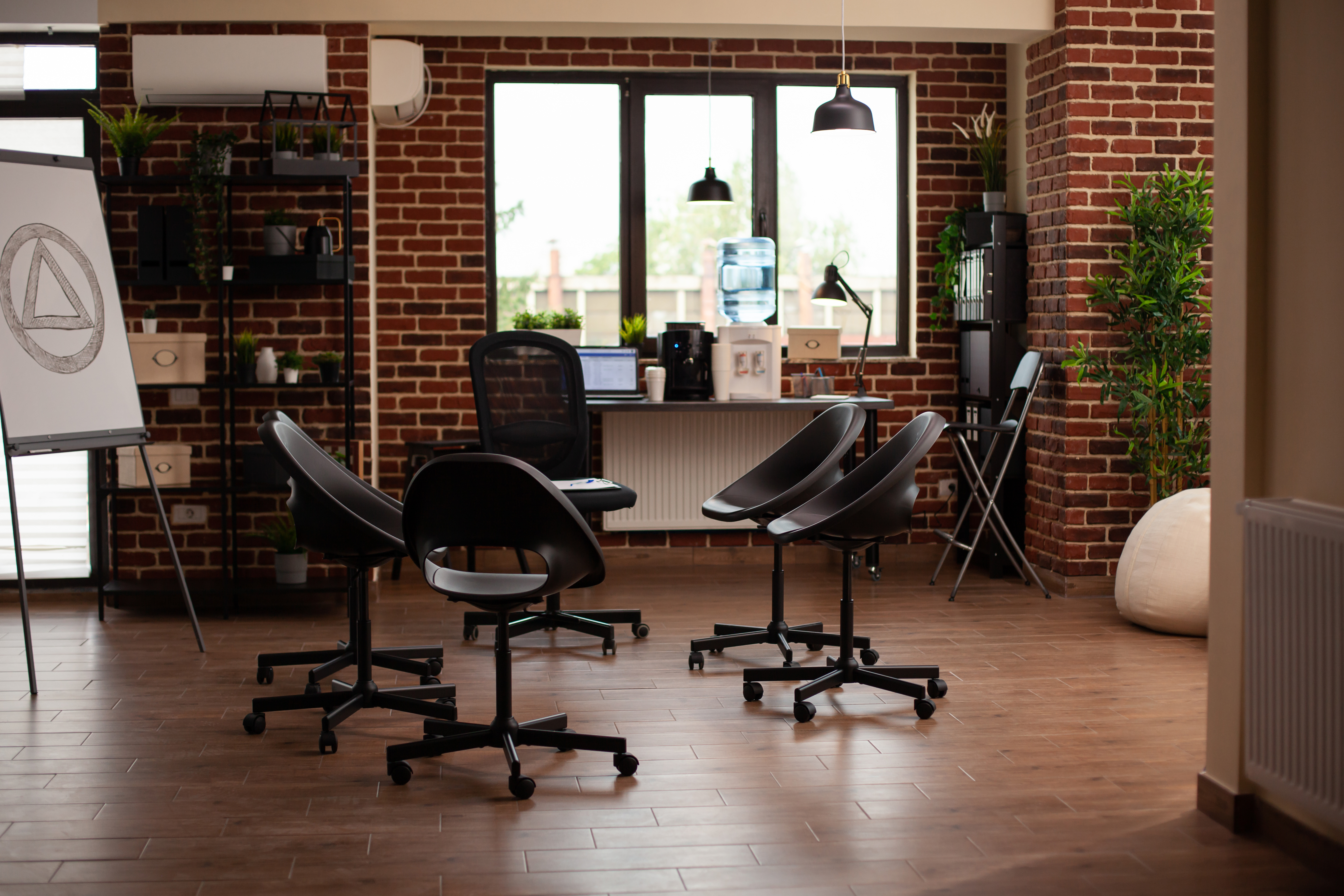 Empty space prepared for aa meeting and group therapy, with chairs in circle. Nobody in room used for psychotherapy session and communication against acohol addiction problems.